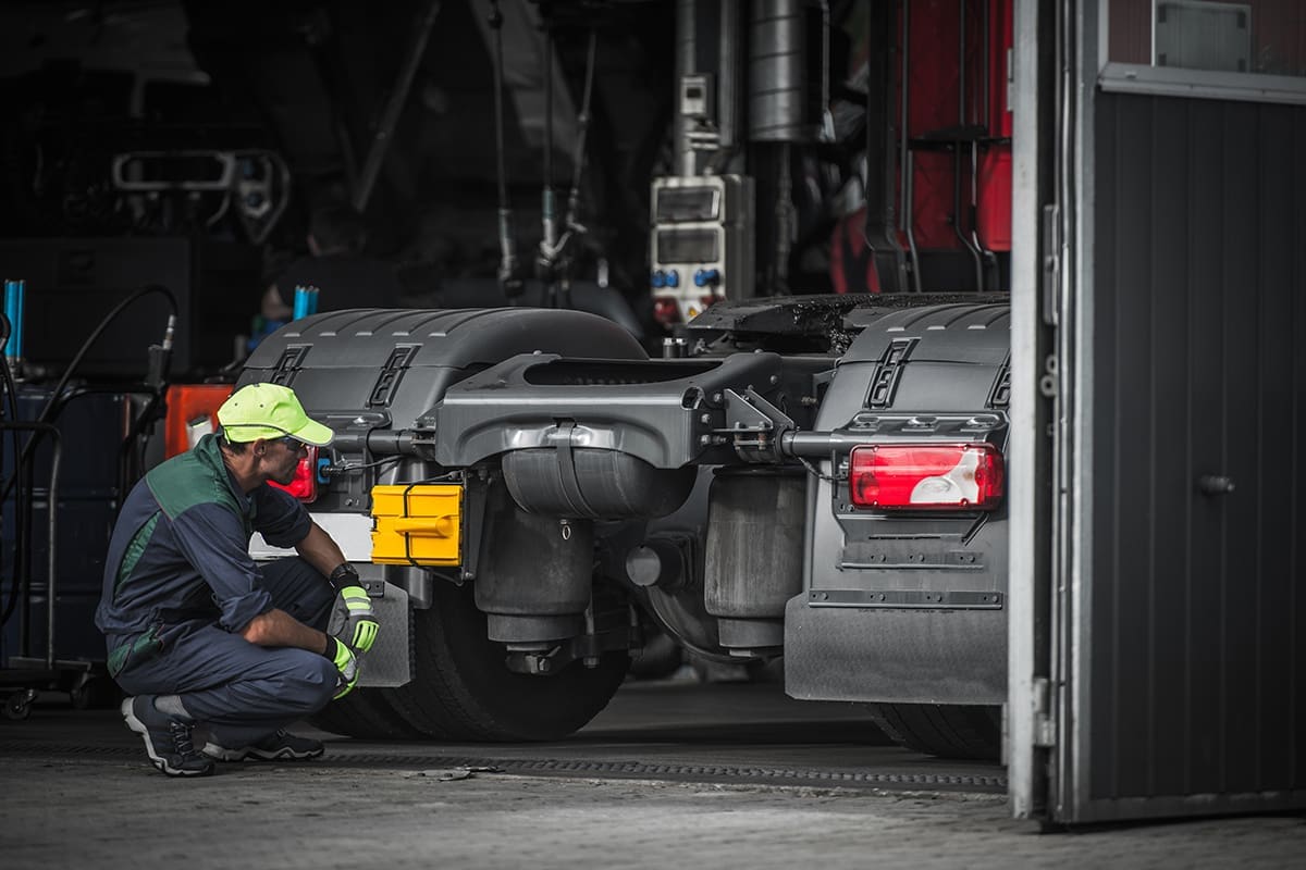 Professional Automotive Caucasian Mechanic Repair Semi Truck Diesel Engine Close Up.